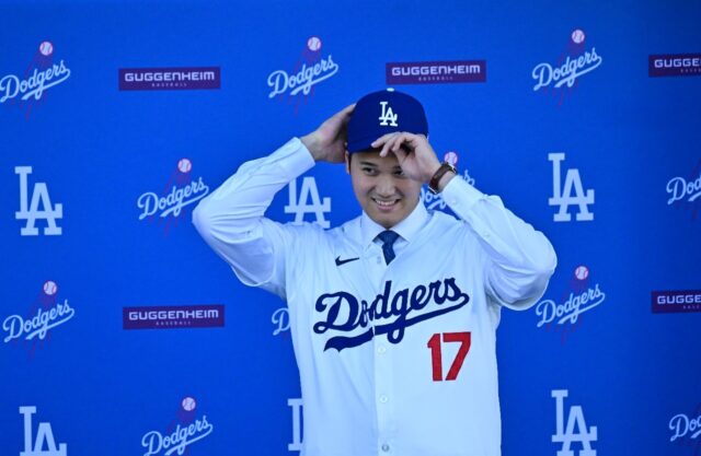 Japanese superstar Shohei Ohtani dons the cap and jersey of his new Major League Baseball