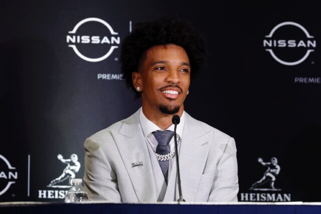 Louisiana State University quarterback Jayden Daniels talks to reporters before receiving