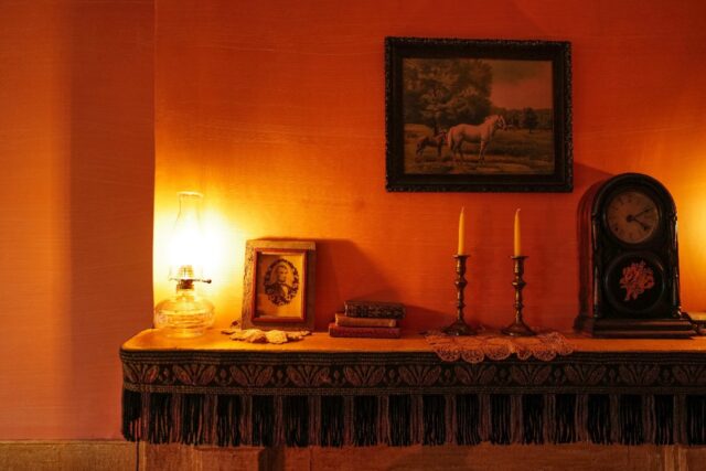 A mantelpiece holds a portrait of president Abraham Lincoln in the recreated dwelling of J