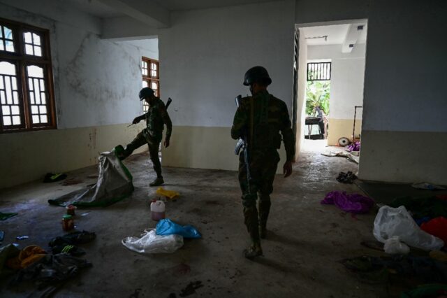 Members of the ethnic minority armed group Ta'ang National Liberation Army walk through a