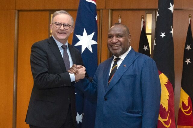 Papua New Guinea Prime Minister James Marape (R) shakes hands with Australian Prime Minist