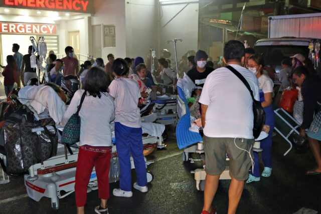 Patients are evacuated from a hospital in Butuan City after a magnitude 7.6 earthquake str