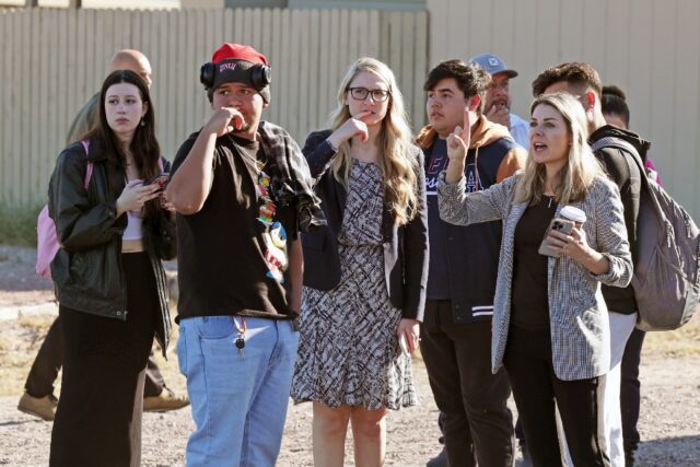 People stand by following a shooting at the University of Nevada, Las Vegas, campus on Dec