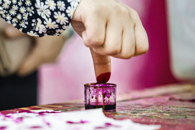 Proof of voting: an Egyptian woman stains her thumb with ink after voting in Cairo