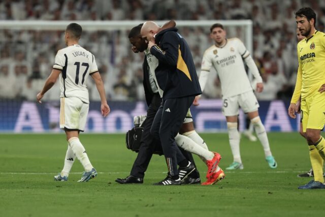 Real Madrid's Austrian defender David Alaba is helped to leave the pitch after suffering a