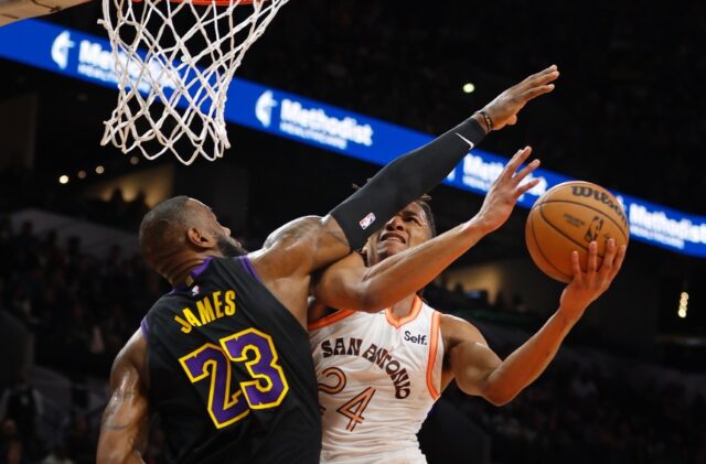 San Antonio's Devin Vassell is fouled by LeBron James of the Los Angeles Lakers in the Spu