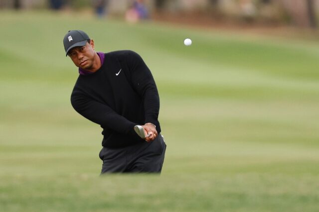 Tiger Woods plays a shot on the 18th hole during a pro-am ahead of playing the weekend's P