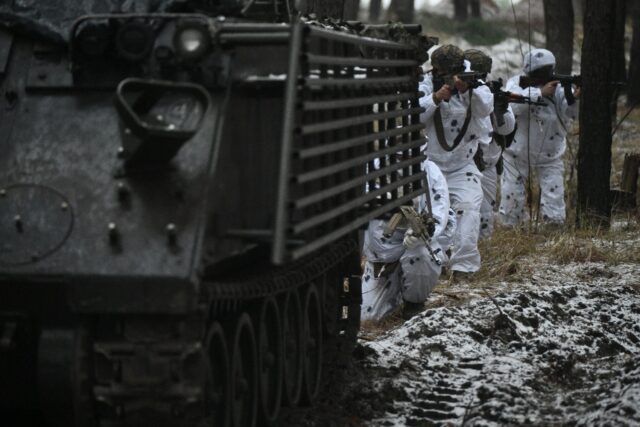 Ukrainian servicemen in snow camouflage take part in the Kharkiv region on December 1, 202