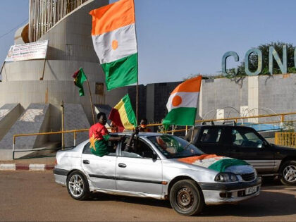 TOPSHOT - Supporters of the Alliance Of Sahel States (AES) drive with flags as they celebr