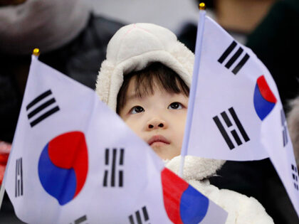 A South Korean fan waves a flag during the ladies' 500 meters short track speedskatin