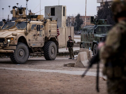 US soldiers stand guard in Hassakeh, northeast Syria, Thursday, Jan. 27, 2022. With a spec