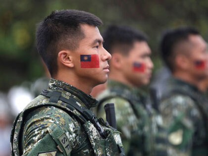 Taiwanese soldiers have Taiwan national flags painted on their faces during National Day c