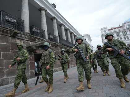 Soldiers patrol outside the government palace during a state of emergency in Quito, Ecuado