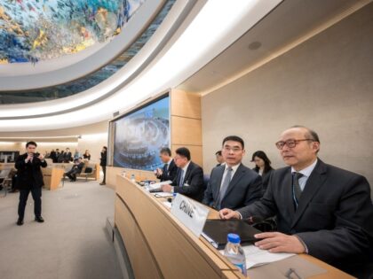 Heads the Chinese Mission to the UN in Geneva Chen Xu (R) sits with a file prior to the re