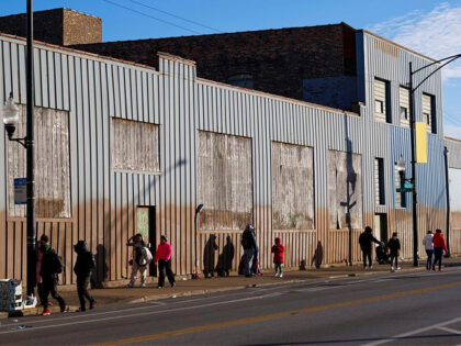 People stand outside a migrant shelter near the 2300 block of South Halsted Street on Dec.