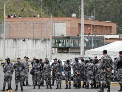 Police forces stand guard outside the Turi prison as inmates hold prison guards hostage, i