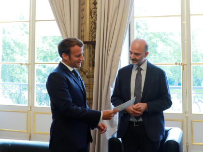 French President Emmanuel Macron (L) receives the annual financial report on the French Pr