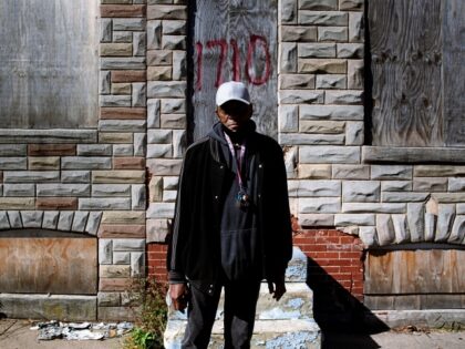 Harry Bogier stands in front of abandoned homes in his Broadway East neighborhood block w