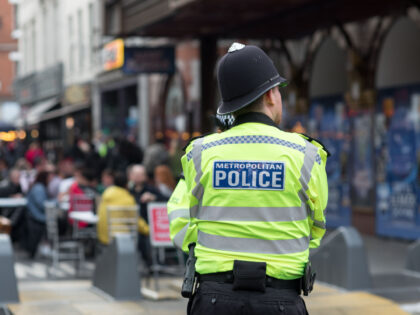 LEICESTER SQUARE, LONDON, UNITED KINGDOM - 2021/06/30: A police marshal overseeing diners