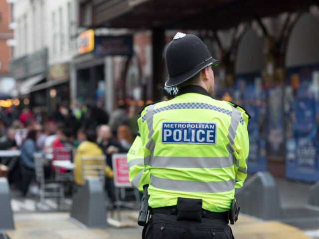 LEICESTER SQUARE, LONDON, UNITED KINGDOM - 2021/06/30: A police marshal overseeing diners in Soho, London. In recent weeks, the number of confirmed covid cases in the UK has been on the rise, and has reached the highest ever since the re-opening of economic activities. Among the surge is the emergence …