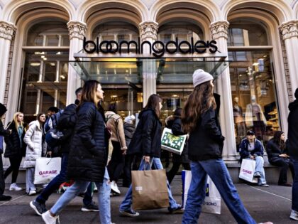 Shoppers walk past a Bloomingdale's store in the SoHo neighborhood of New York, US, o