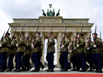 Members of a German honor guard march past the Brandenburg Gate in Berlin as they rehearse