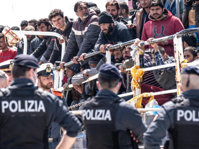 CATANIA, ITALY - APRIL 12: A group of police officers await the disembarkation of the 600 migrants in the port of Catania on April 12, 2023 in Catania, Italy. The Italian Coast Guard escorted a fishing trawler with around 700 migrants and refugees who were rescued some 100 miles off …