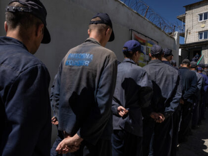 LVIV REGION, UKRAINE - AUGUST 3: Prisoners line up for lunch outside the Russian prisoner