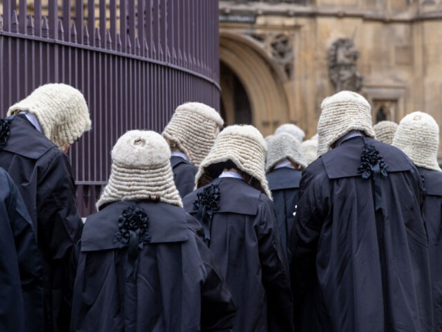 Judges and members of the King's Counsel wearing ceremonial dress leave Westminster A
