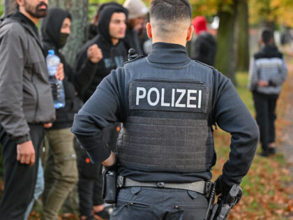 11 October 2023, Brandenburg, Forst: Illegal migrants are guarded by a Federal Police offi