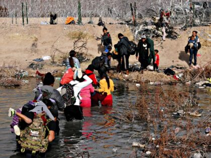Migrants cross the Rio Bravo river, known as Rio Grande in the United States, into the US