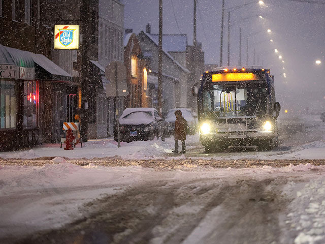 A bus drops off a commuter near the Berwyn Metra stop as a winter storm hits the Chicago area on Friday, Jan. 12, 2024. (Antonio Perez/Chicago Tribune/Tribune News Service via Getty Images)