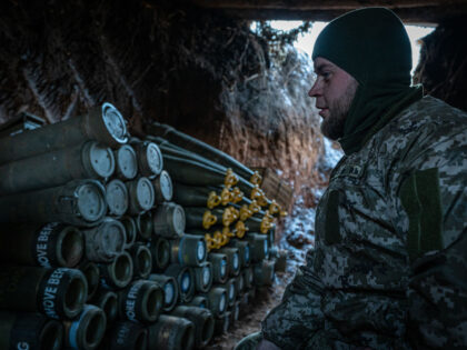 DONETSK OBLAST, UKRAINE - JANUARY 22: A Ukrainian soldier waits for orders near artillery