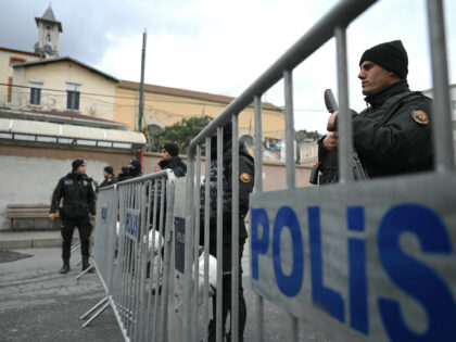 Turkish anti riot police officers block the street of Santa Maria church after an attack i