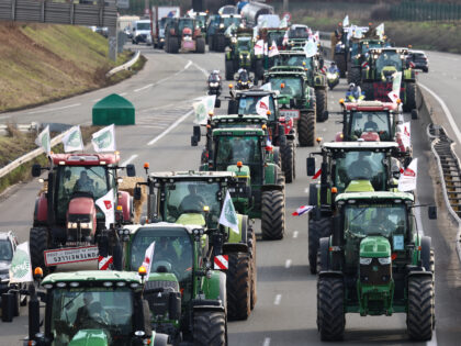 French farmers drive tractors to take part in a road block protests on the A6 highway near