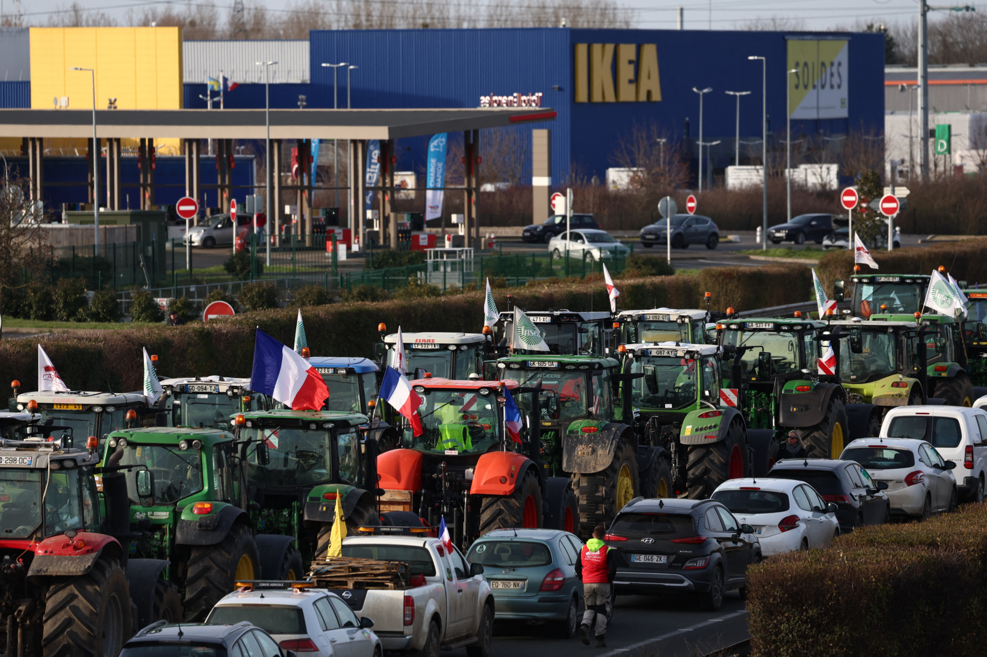 Farmers driving tractors take part in a road blockage of the A6 highway near Villabe, south of Paris, on January 29, 2024, amid nationwide protests called by several farmers unions on pay, tax and regulations. Local branches of major farmer unions FNSEA and Jeunes Agriculteurs announced on January 27, 2024, a "siege of the capital for an indefinite period" starting at 2 p.m. on January 29, 2024, as some farmers deem the government's announcements in favor of the sector are insufficient. (Photo by EMMANUEL DUNAND / AFP) (Photo by EMMANUEL DUNAND/AFP via Getty Images)