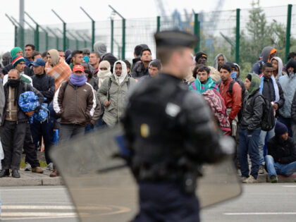 TOPSHOT - Illegal immigrants wait to be expelled from their camp at Calais on May 28, 2014