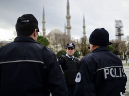 TOPSHOT - Turkish police officers stand guard near the Blue Mosque in Istanbul's tourist h