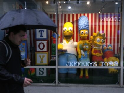 Black Friday shoppers walk past the display window at Jeffrey’s Toys store in San Franci
