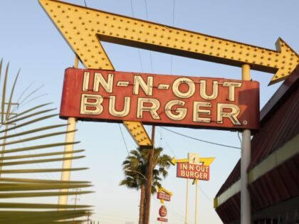 In-N-Out Burger signs, two in the foreground from the fast food chain's original loca