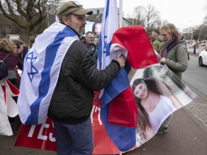 THE HAGUE, NETHERLANDS - JANUARY 12: A pro Israel protester folds up a banner showing Naam