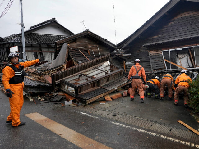 Rescue workers search a collapsed house caused by powerful earthquake …