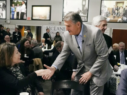 Sen. Joe Manchin (D-WV) shakes hands with guests during the 'Politics and Eggs'