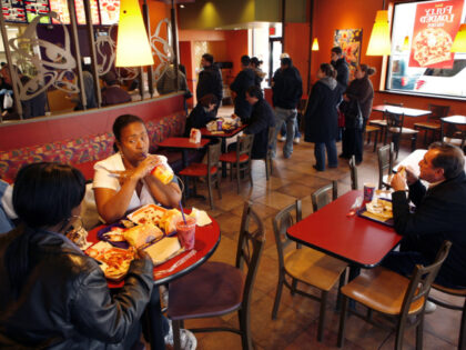 Customers have lunch at a newly remodeled Taco Bell in Flushing, New York, including Clayd