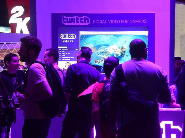 People wait in line at booth for Twitch, the official Livestream Partner of E3 during the