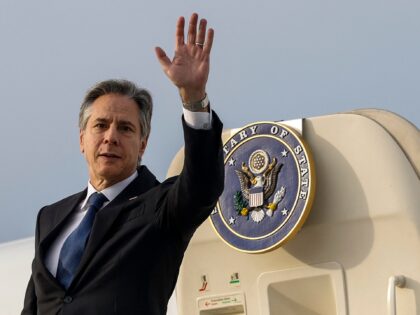 US Secretary of State Antony Blinken waves as he boards a plane to depart after meeting wi
