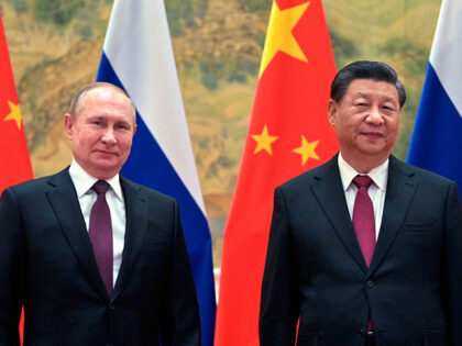 Chinese President Xi Jinping, right, and Russian President Vladimir Putin pose for a photo
