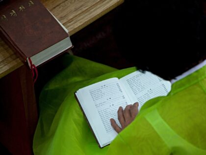 PYONGYANG, NORTH KOREA - SEPTEMBER 07: North Korean worshiper reading the bible during a s