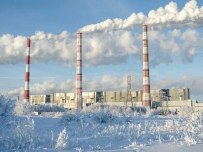 Gas power station in cold winter landscape. Pipes with smoke. Energy industry concept.