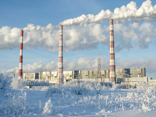 Gas power station in cold winter landscape. Pipes with smoke. Energy industry concept.